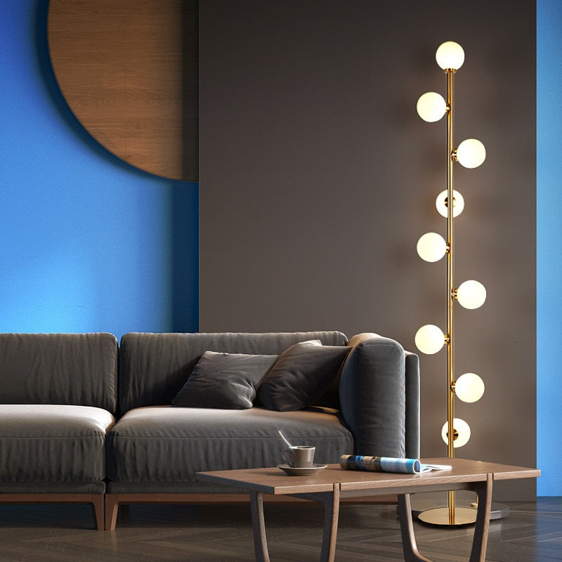 Lights of Scandinavia - Nucleic - Modern LED standing lamp with frosted glass ball fixtures. Nickel gold plated steel body. Suitable for bedrooms, halls or next to a lonely wall. 9 light sources with a coverage of approximately 6-12 square meters, using the included LED Bulbs. Base diameter: 25cm Glass ball diameter: 10cm Specifications Light Source 9x LED Bulbs Base Type G4 Power Consumption 16-20W Is Bulbs Included Yes Dimmable