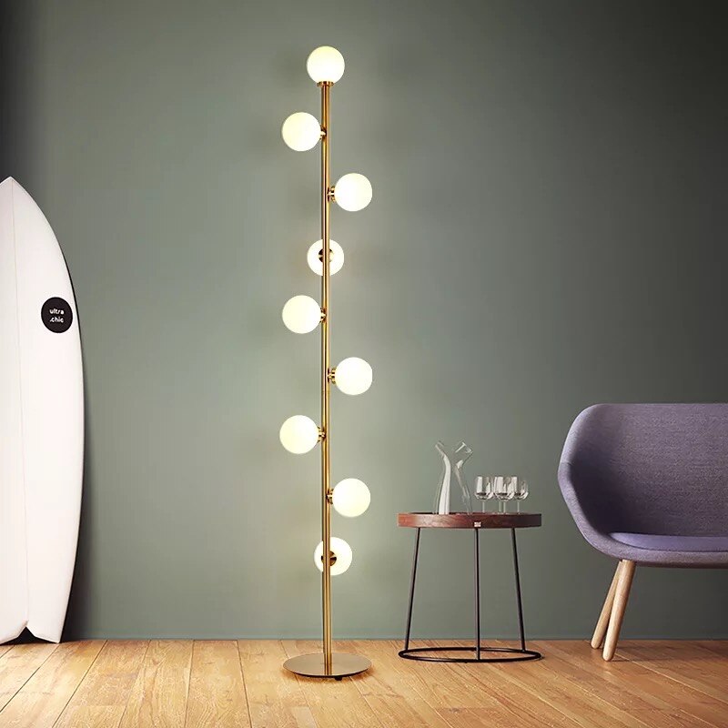 Lights of Scandinavia - Nucleic - Modern LED standing lamp with frosted glass ball fixtures. Nickel gold plated steel body. Suitable for bedrooms, halls or next to a lonely wall.  9 light sources with a coverage of approximately 6-12 square meters, using the included LED Bulbs. Base diameter: 25cm Glass ball diameter: 10cm Specifications Light Source 9x LED Bulbs Base Type G4 Power Consumption 16-20W Is Bulbs Included Yes Dimmable